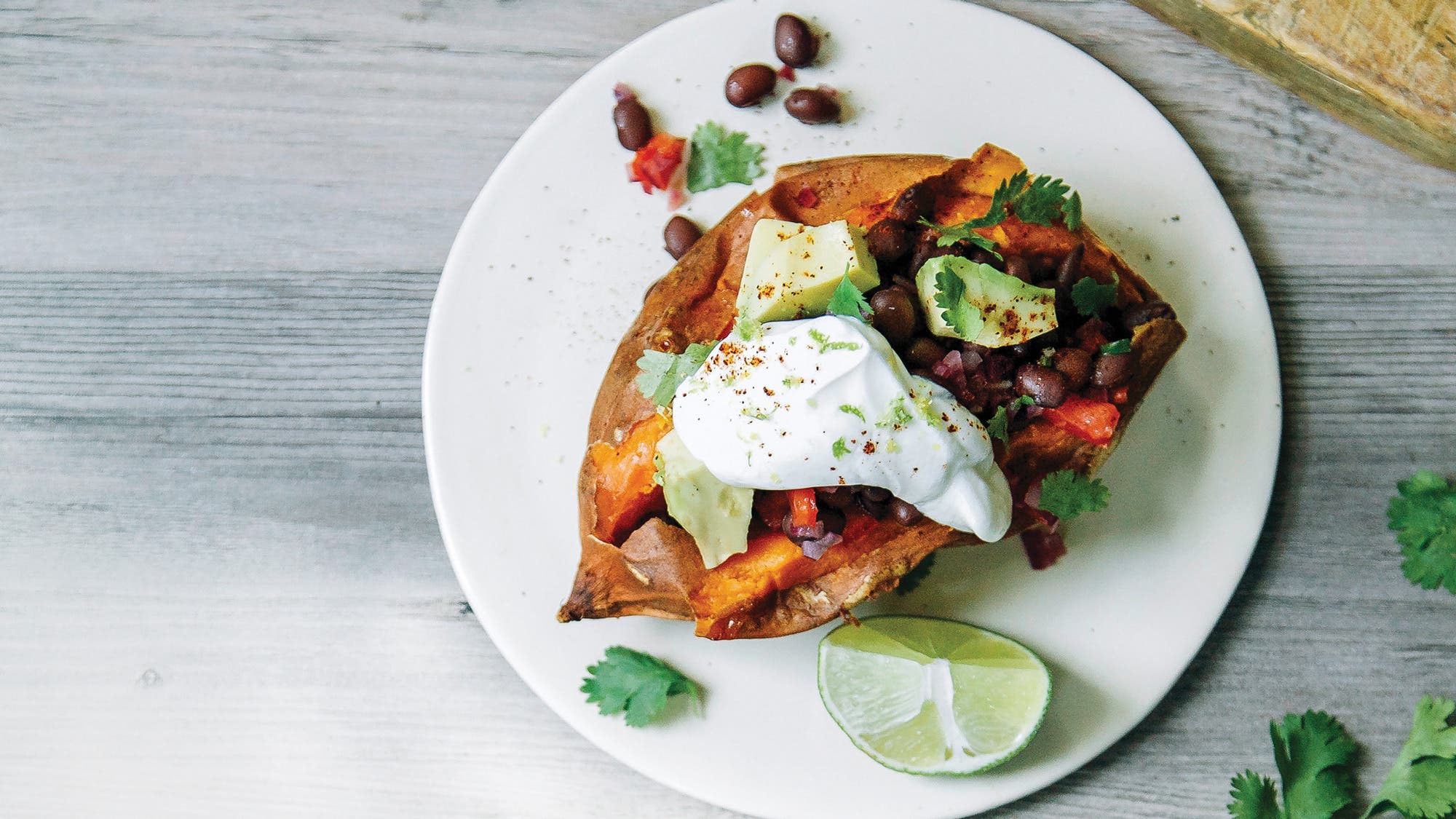 Stuffed Sweet Potatoes with Spicy Black Beans, Avocado & Lime Cream recipe