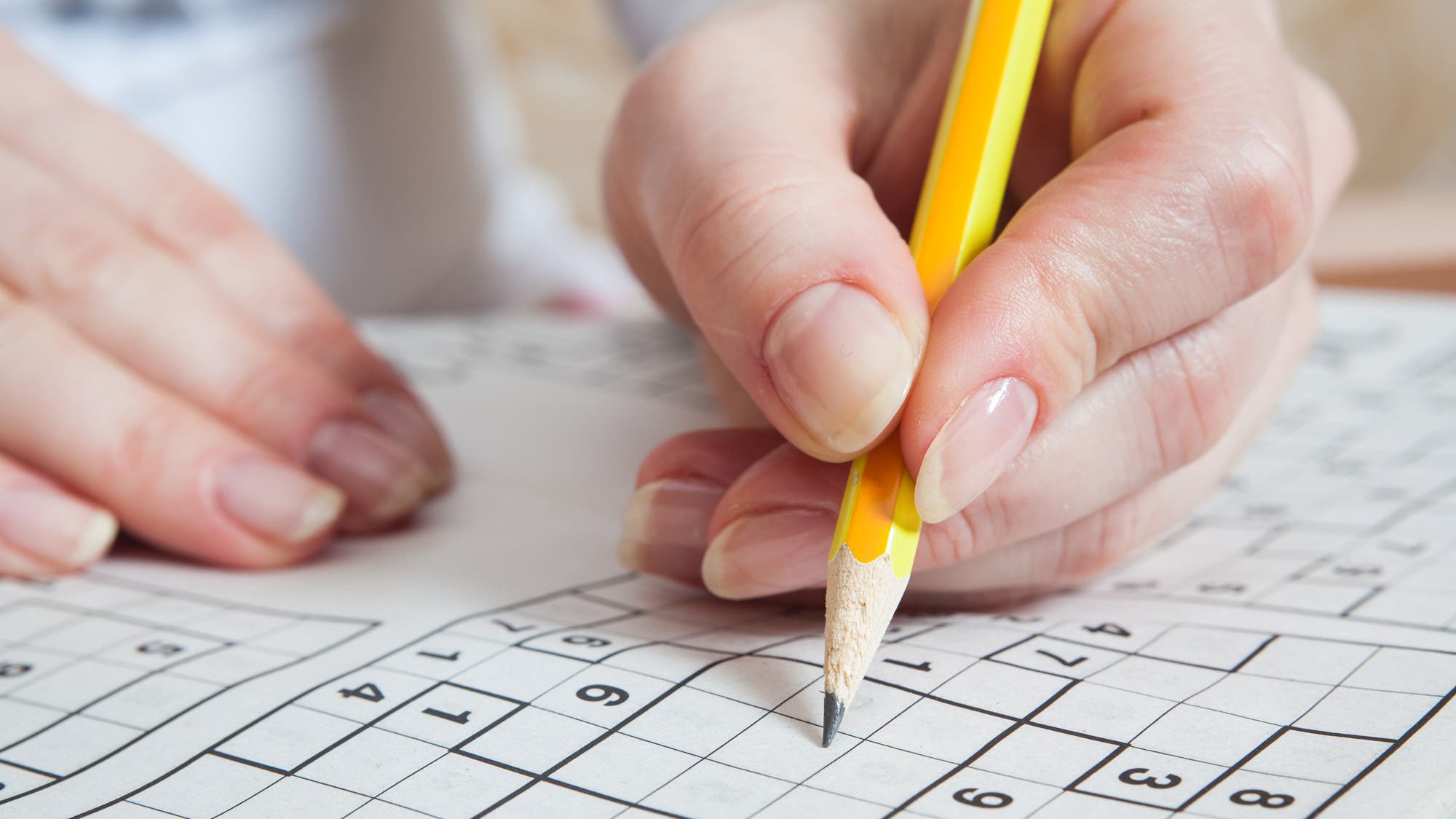 Smarter Supplements - person filling in a crossword puzzle