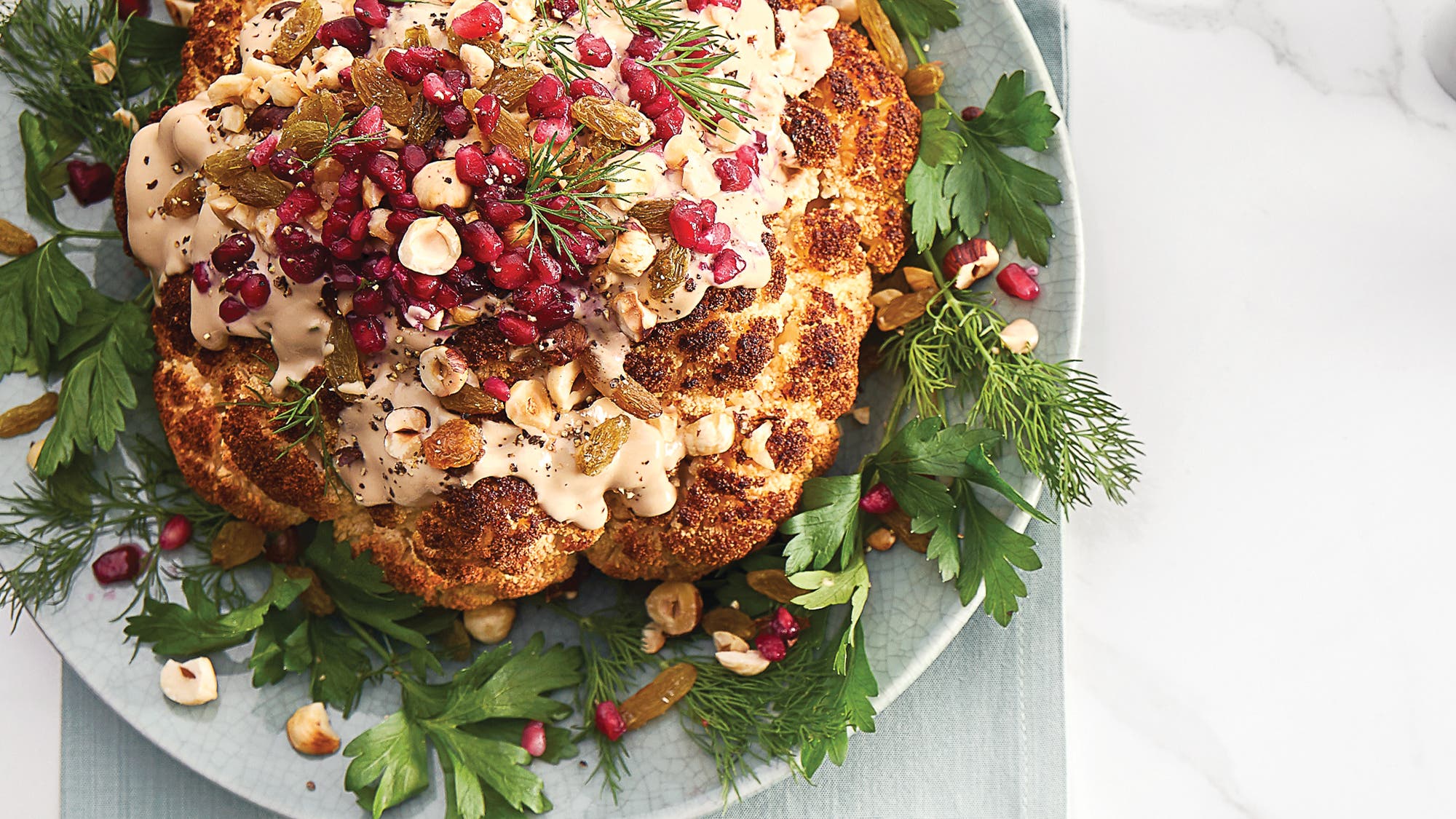 Whole-Roasted-Cauliflower-with-Pomegranate-Tahini-Sauce-and-Raisins-&-Hazelnuts_89-web None