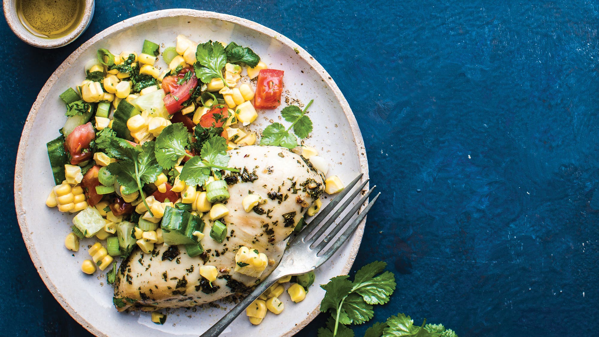 Cilantro-Chicken-with-Corn-Salad_80-web Cilantro Chicken with Corn Salad - Forego the basic salt-and-pepper oven-baked white meat. These chicken breast recipes will have you falling in love with this bird all over again.
