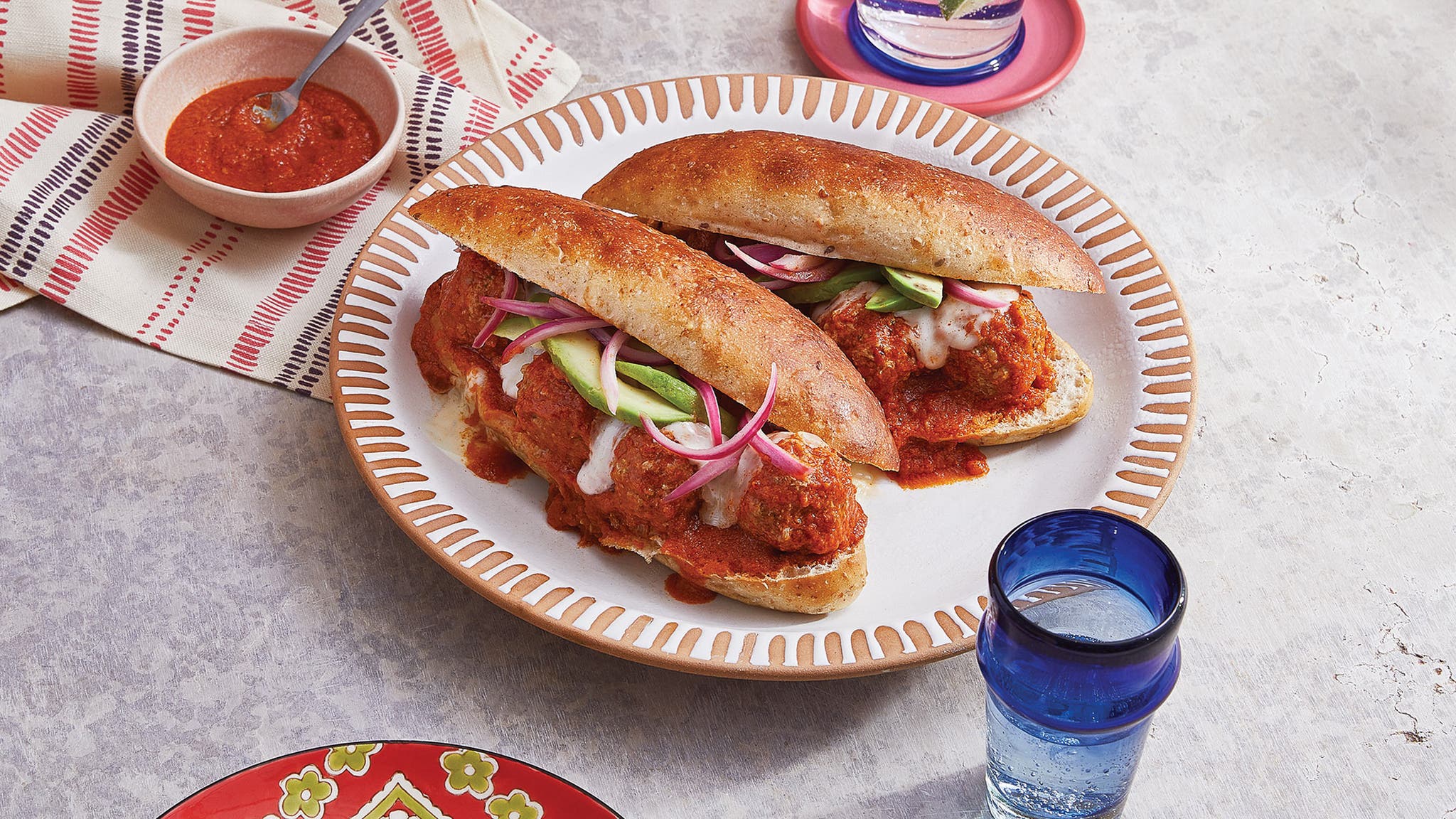 Two meatball tortas on a plate