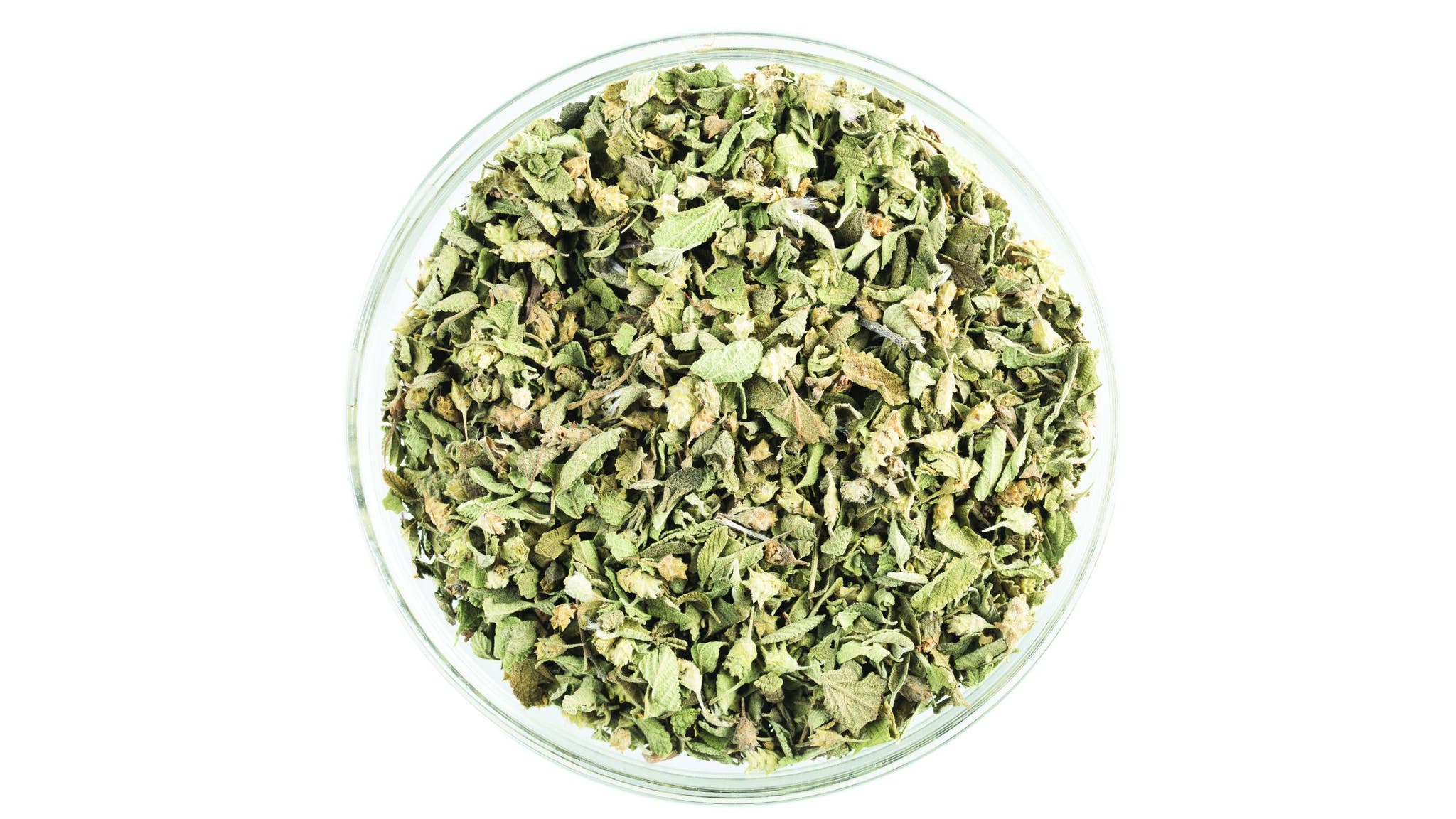 Bowl of Mexican oregano on a white background
