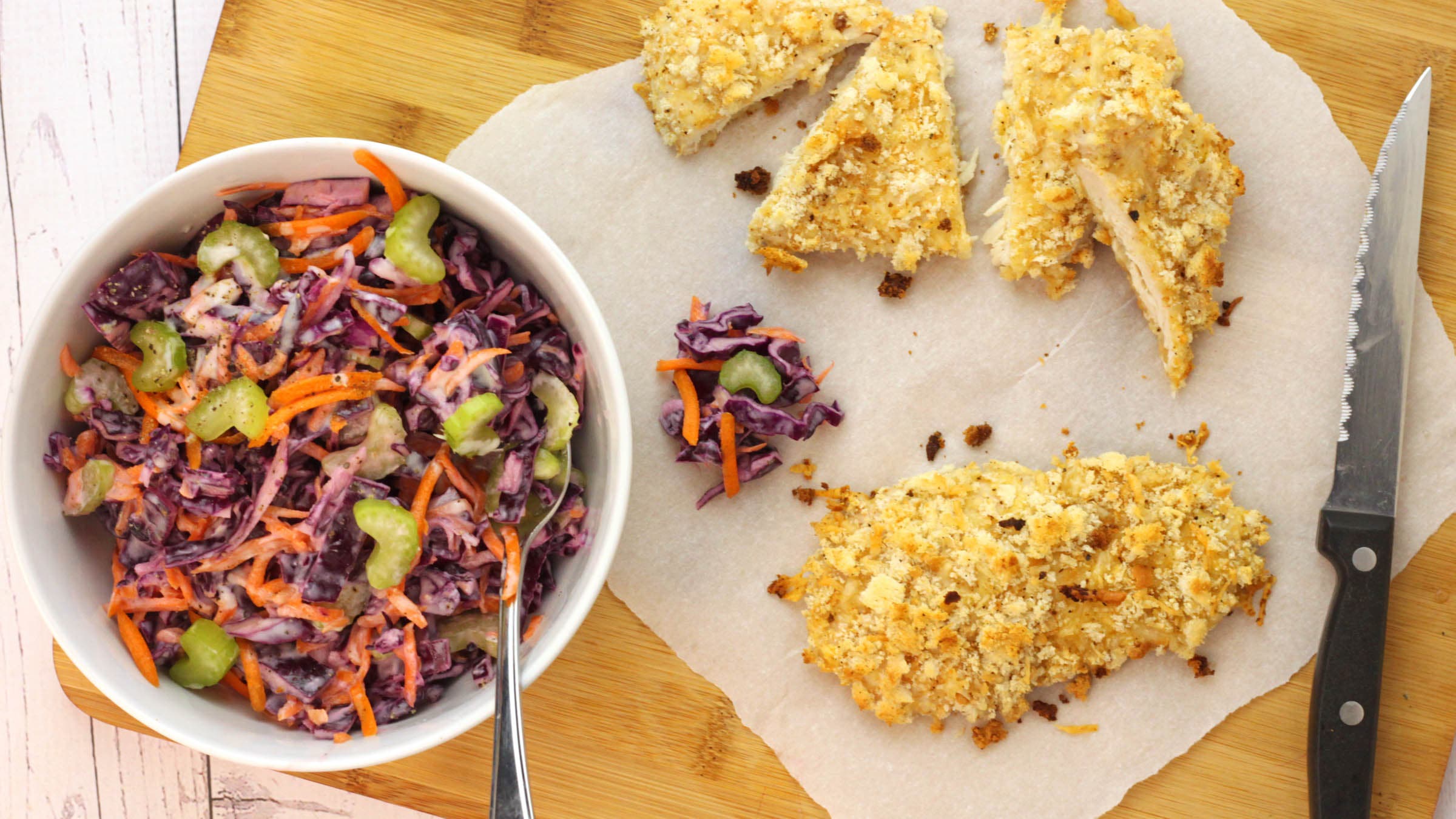 Bowl of coleslaw next to sliced not-fried chicken
