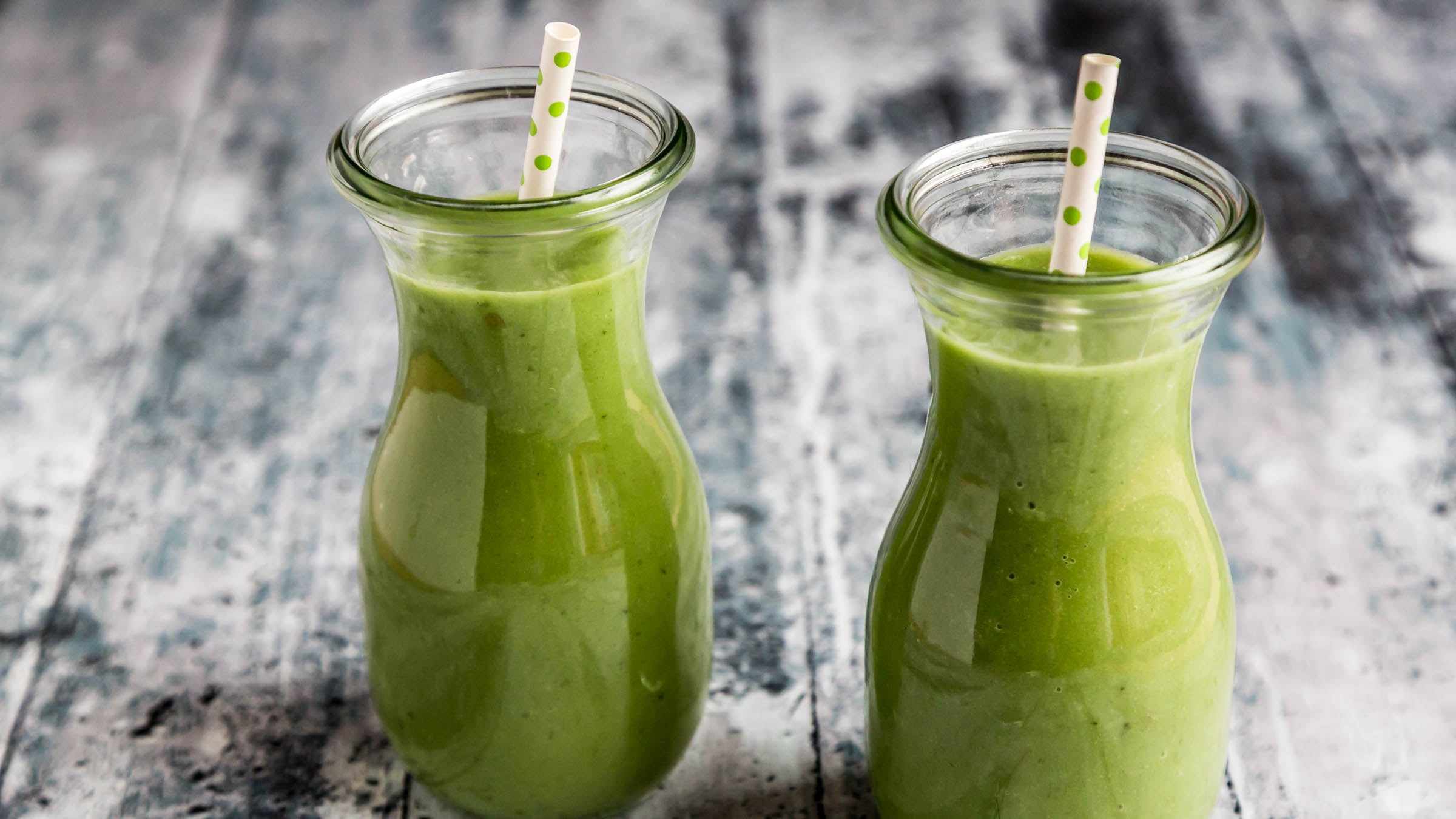 Green smoothie in mini carafes with straws